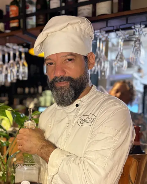 Chef Marcio in his whites, behind the bar