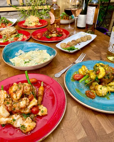Pasta, prawns and gnocchi on speckled plates