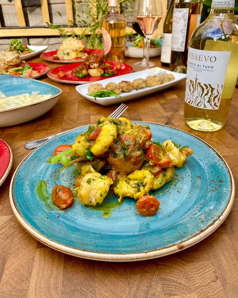 Gnocchi and prawns on a blue plate