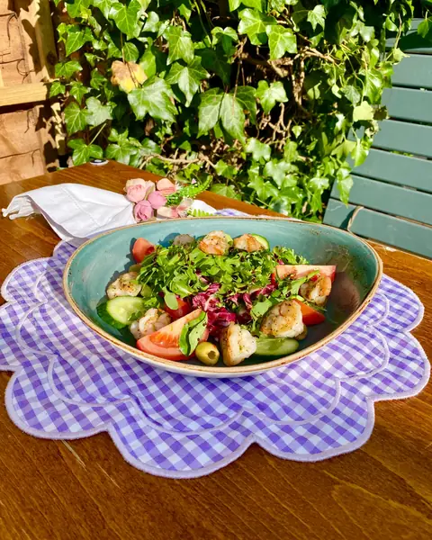 A salad bowl on a gingham tablecloth