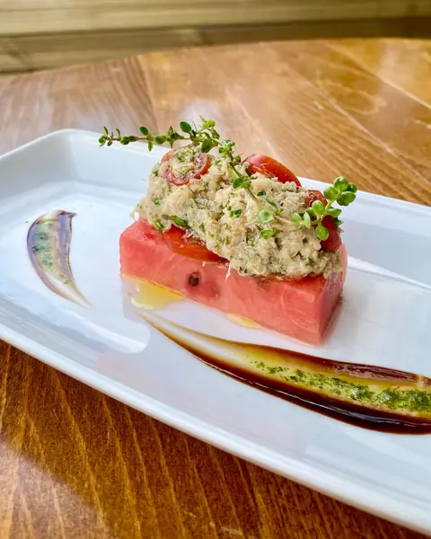 Watermelon topped with tartare and a balsamic swirl
