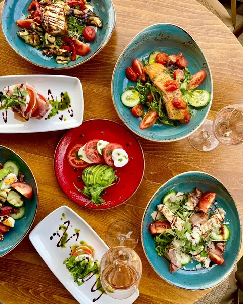A spread of starters on blue plates