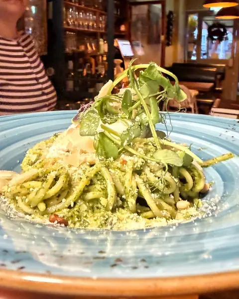 Linguine with pesto and Parmigiano on a turquoise plate in the salon
